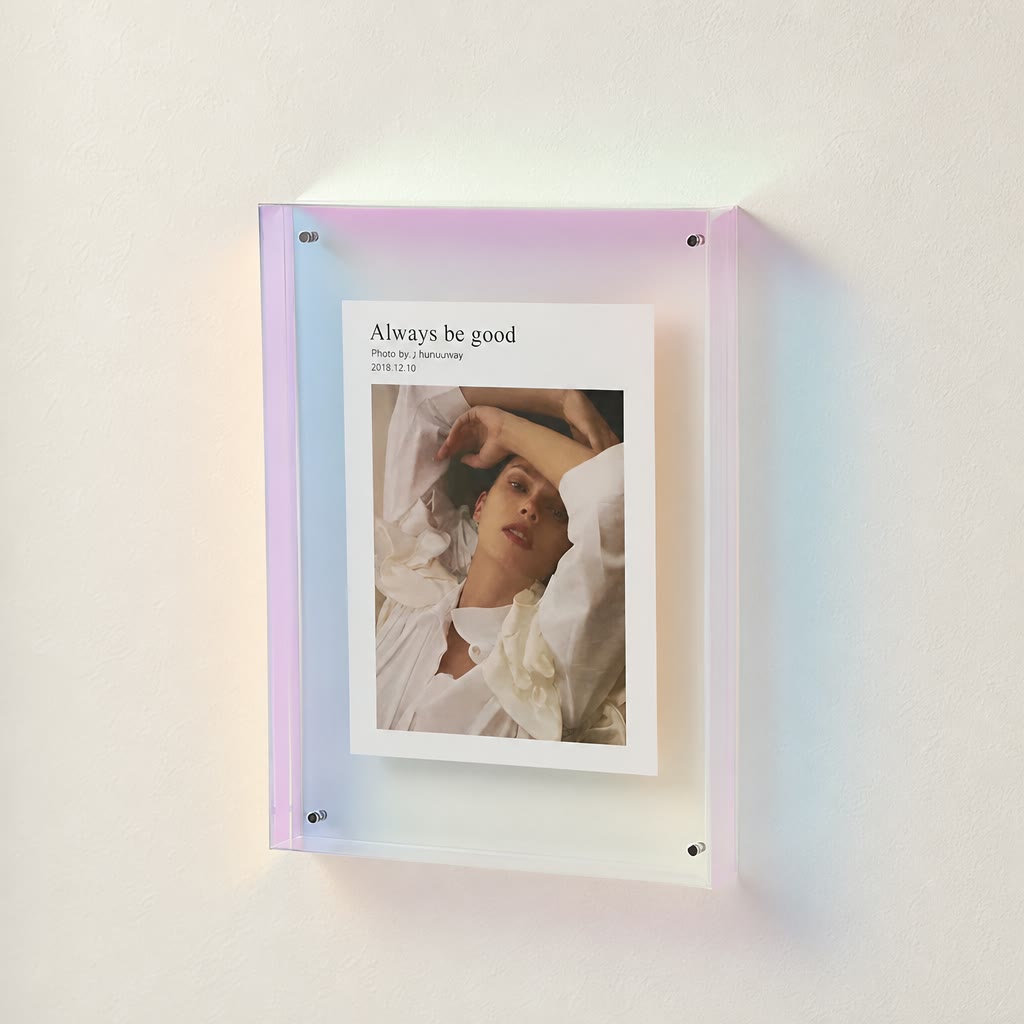 Iridescent acrylic wall frame holding a white photo print with portrait and title text.