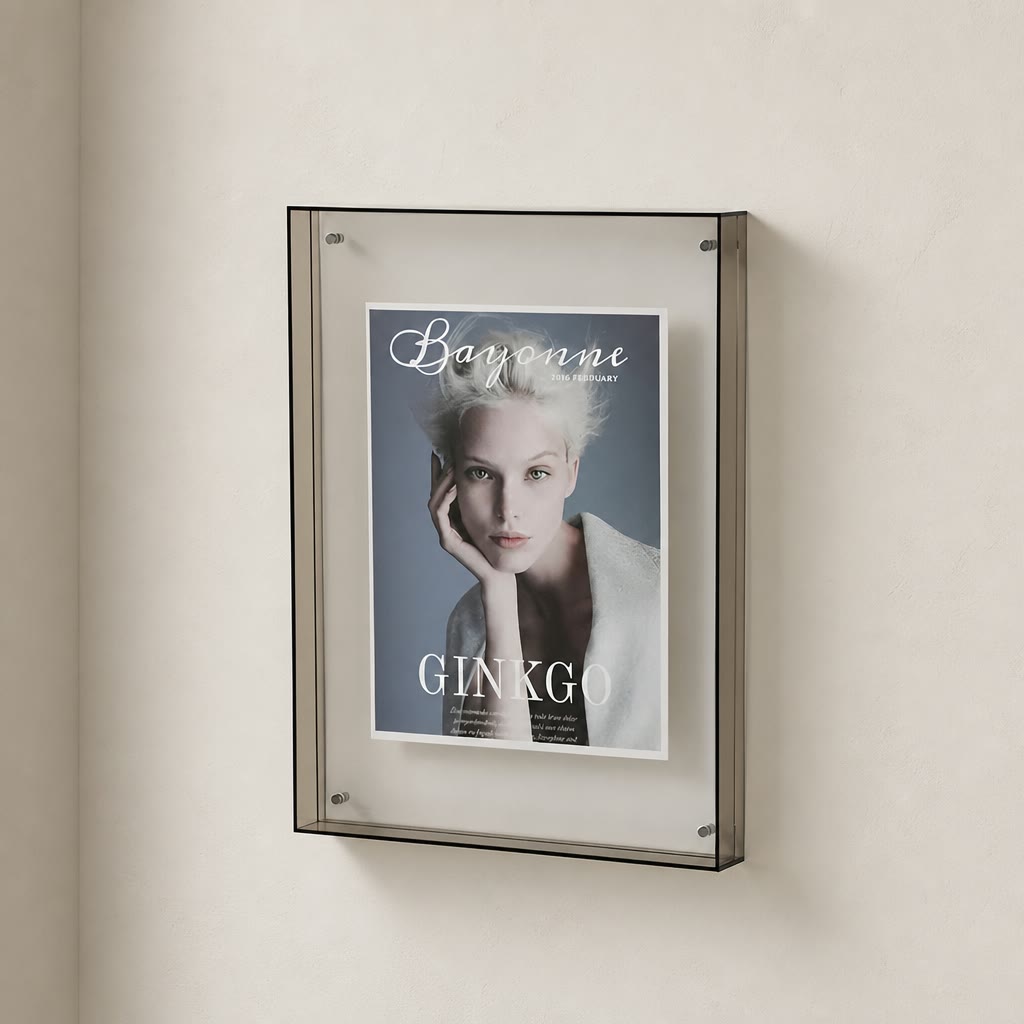 Wall-mounted transparent display frame holding a Bayonne Ginkgo poster.