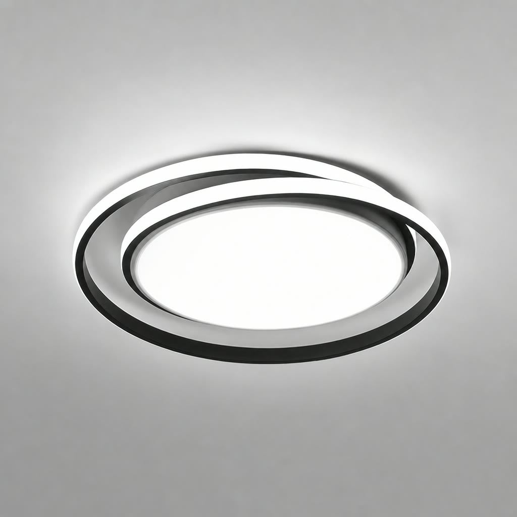 Modern circular LED ceiling light with black rings and glowing white center.