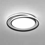 Modern circular LED ceiling light with black rings and glowing white center.