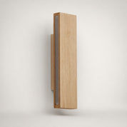 Vertical rectangular wooden wall sconce with a narrow gray inset panel on a plain light background.
