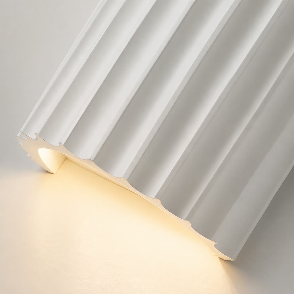 White pleated curtain pooling softly on a warm glowing floor.