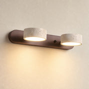 Two warm glowing cylinder lights on a wooden wall-mounted fixture.