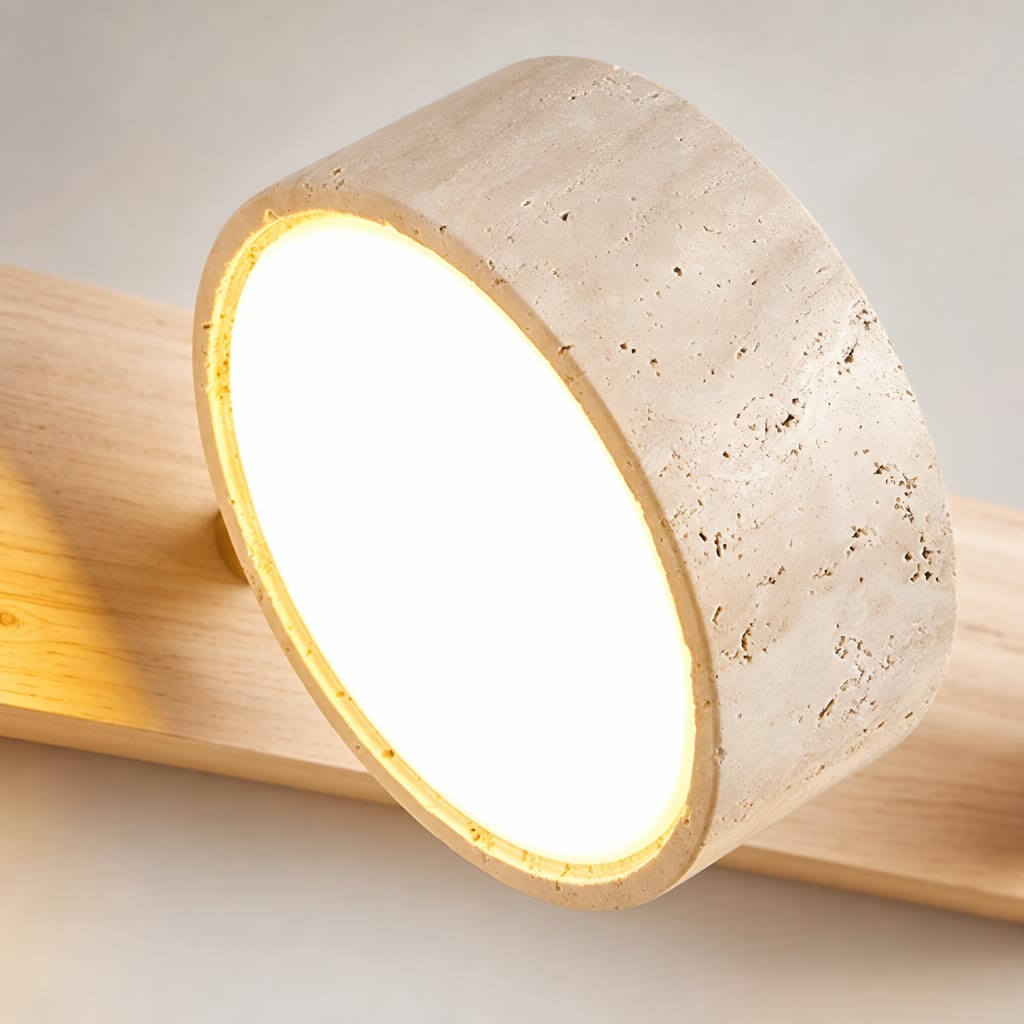 Round stone-textured glowing lamp mounted on a pale wooden rail.