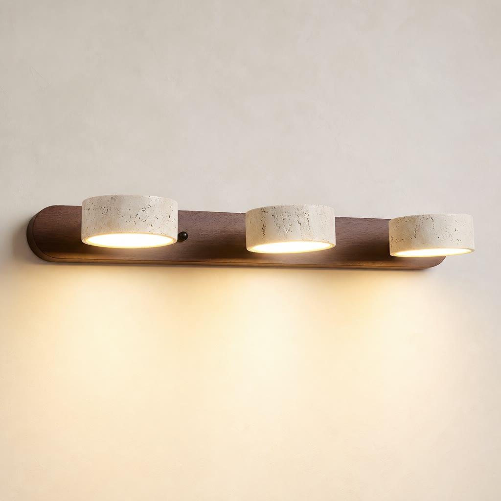 Three-light wall fixture with a dark wood bar and cream speckled cylindrical shades.