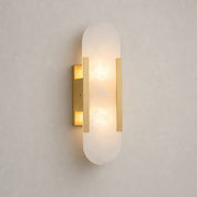 Glowing oval frosted glass wall sconce with slim gold vertical accents.