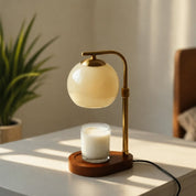 A beige Elegant Glass Candle Warmer Lamp with Soft Orange Glow for Cozy Spaces.