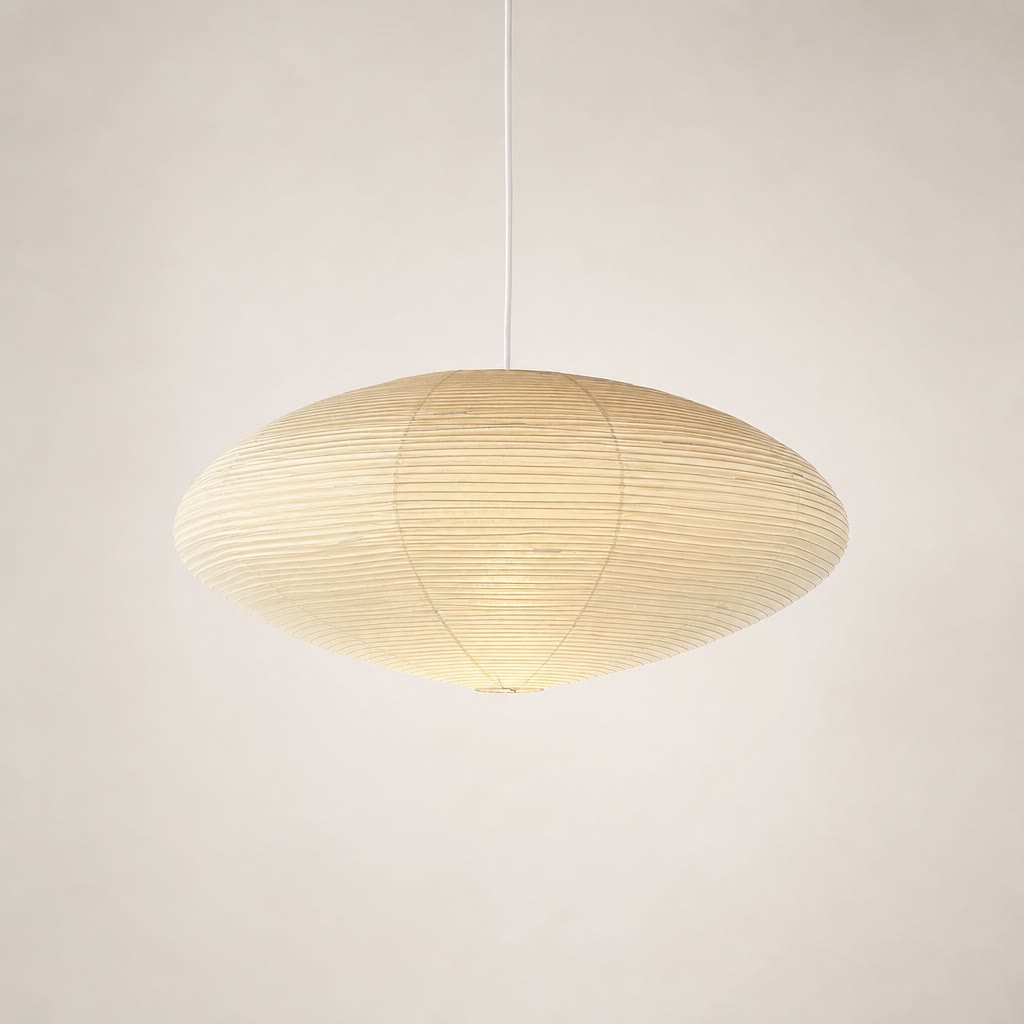 Warm ribbed paper pendant lamp with a wide oval shade hanging from a white cord.
