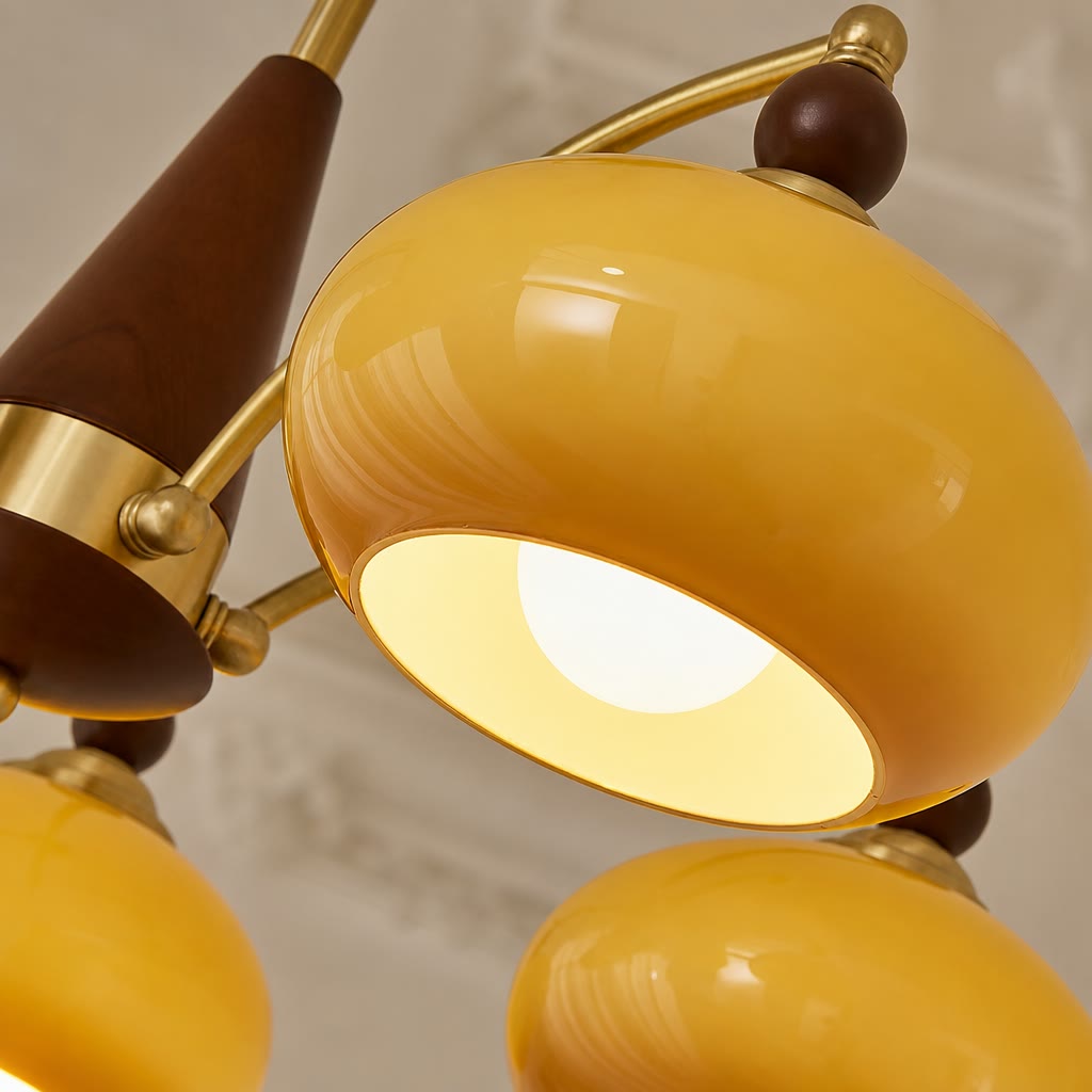 Glossy yellow and brown multi-head ceiling light with gold arms and glowing shades.