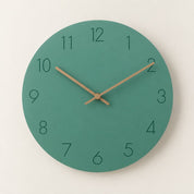 Teal round wall clock with dark numerals and wooden hands on a light neutral background.