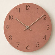 Round terracotta wall clock with black numerals and pale hands.