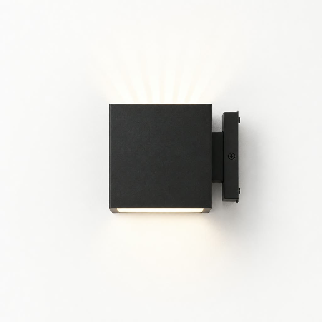 Matte black square exterior wall light with warm glow mounted on a right-side bracket.