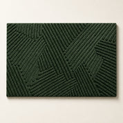 Dark green rectangular textured rug with raised geometric line pattern on a plain light background.
