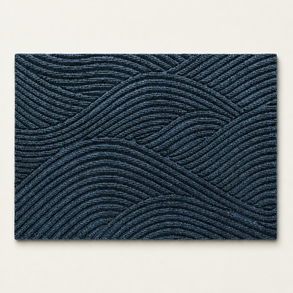 Dark blue rectangular rug with raised geometric wavy line texture on a light background.