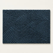 Dark blue rectangular rug with raised geometric wavy line texture on a light background.