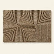 Tan rectangular textured rug with raised concentric arch and circular line patterns.
