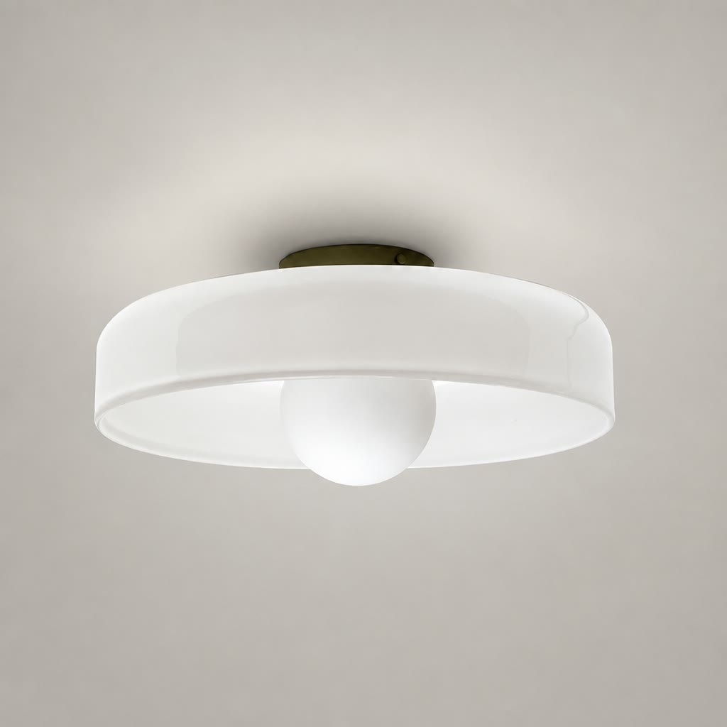 White flush mount ceiling light with round translucent shade and central frosted dome on a pale gray background.