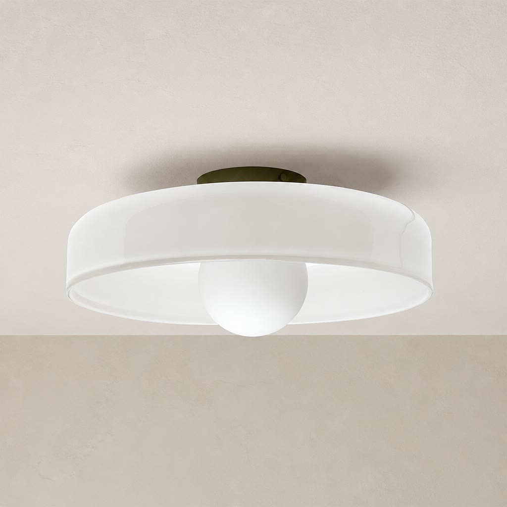 White flush mount ceiling light with a round shade and central globe diffuser.