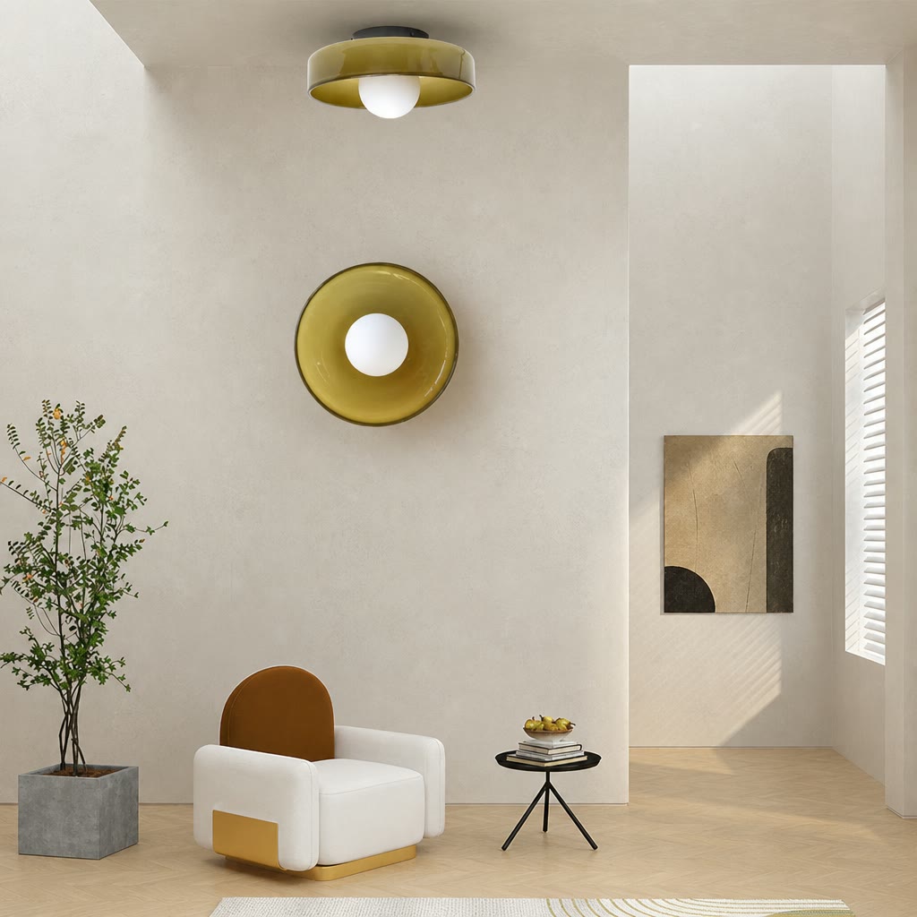 White lounge chair sits below matching amber circular wall and ceiling lights in a minimalist room.