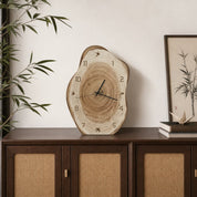 Natural wood slice wall clock with visible tree rings and black hands on a wooden cabinet.