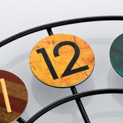 Round yellow number 12 marker mounted on a black metal wire frame.