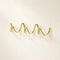 Polished gold wavy wall hook rack on a clean light background.