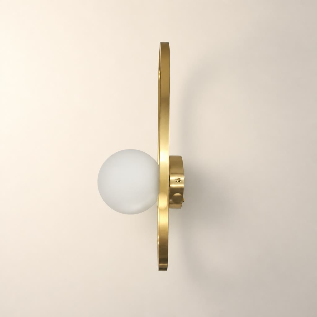 Brass wall sconce with a white glass globe and slim vertical oval frame.
