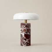 Glossy white mushroom table lamp with brass stem and red marble cylinder base.