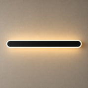 Long black rounded wall light with a white rim casting a warm glow.