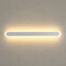Long rounded wall light with a warm glow on a neutral textured wall.