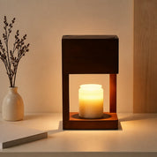 Dark wooden frame lamp with a glowing candle jar on a tabletop.