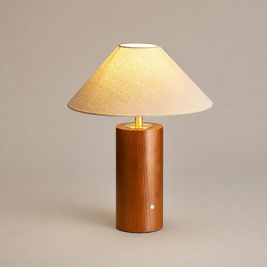 Lit table lamp with beige shade and cylindrical wooden base.