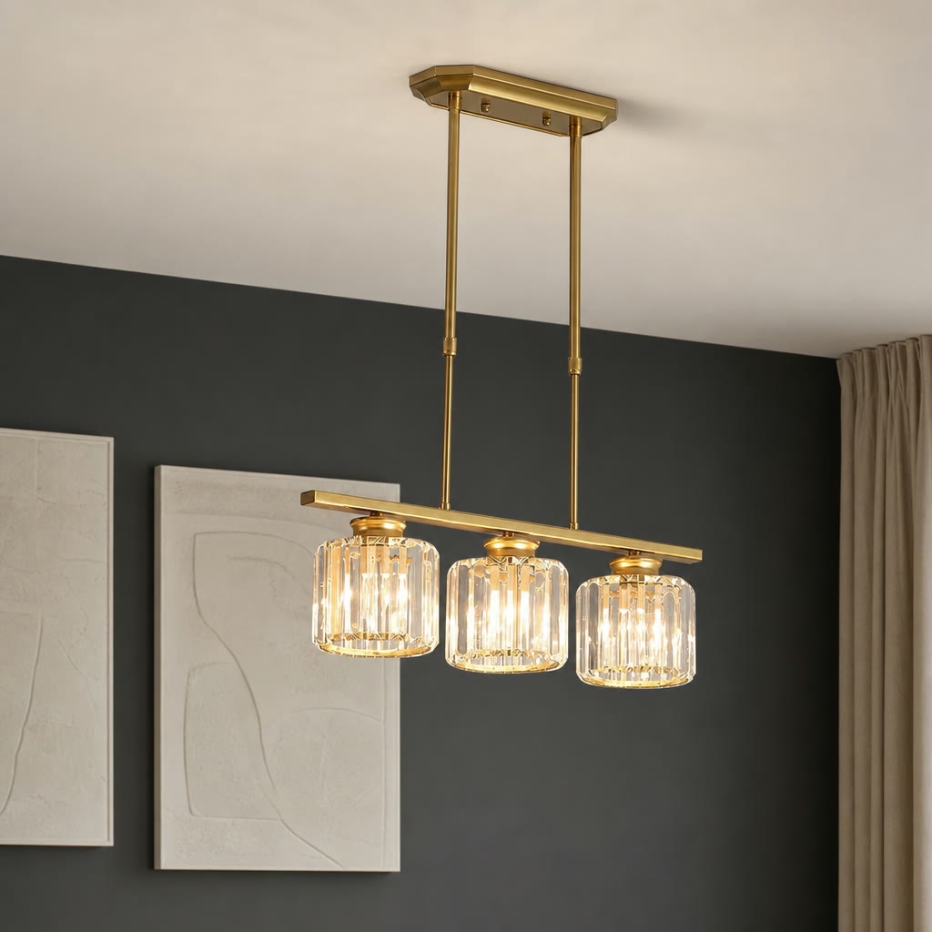 Gold three-light linear pendant chandelier with ribbed glass shades hanging from a ceiling.