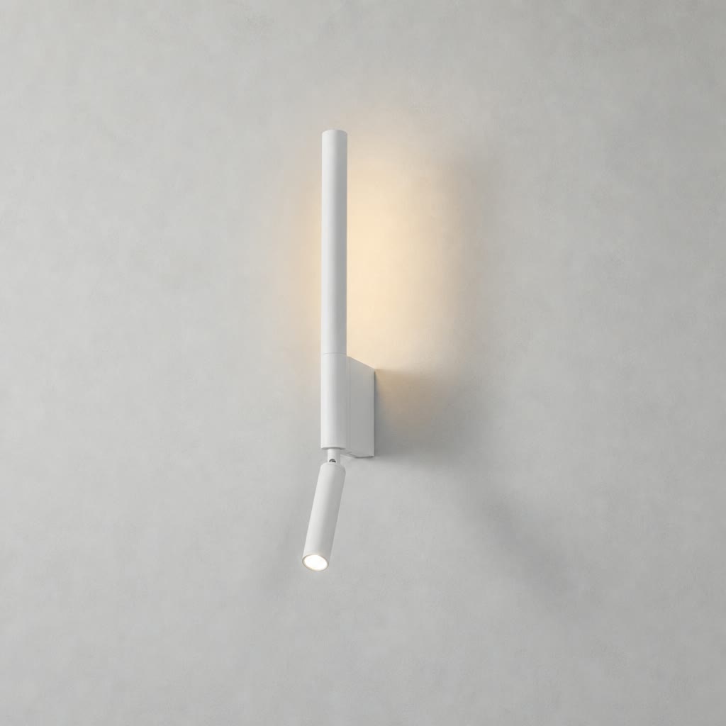 White minimalist wall sconce with vertical tube and angled spotlight glowing on a pale gray wall.