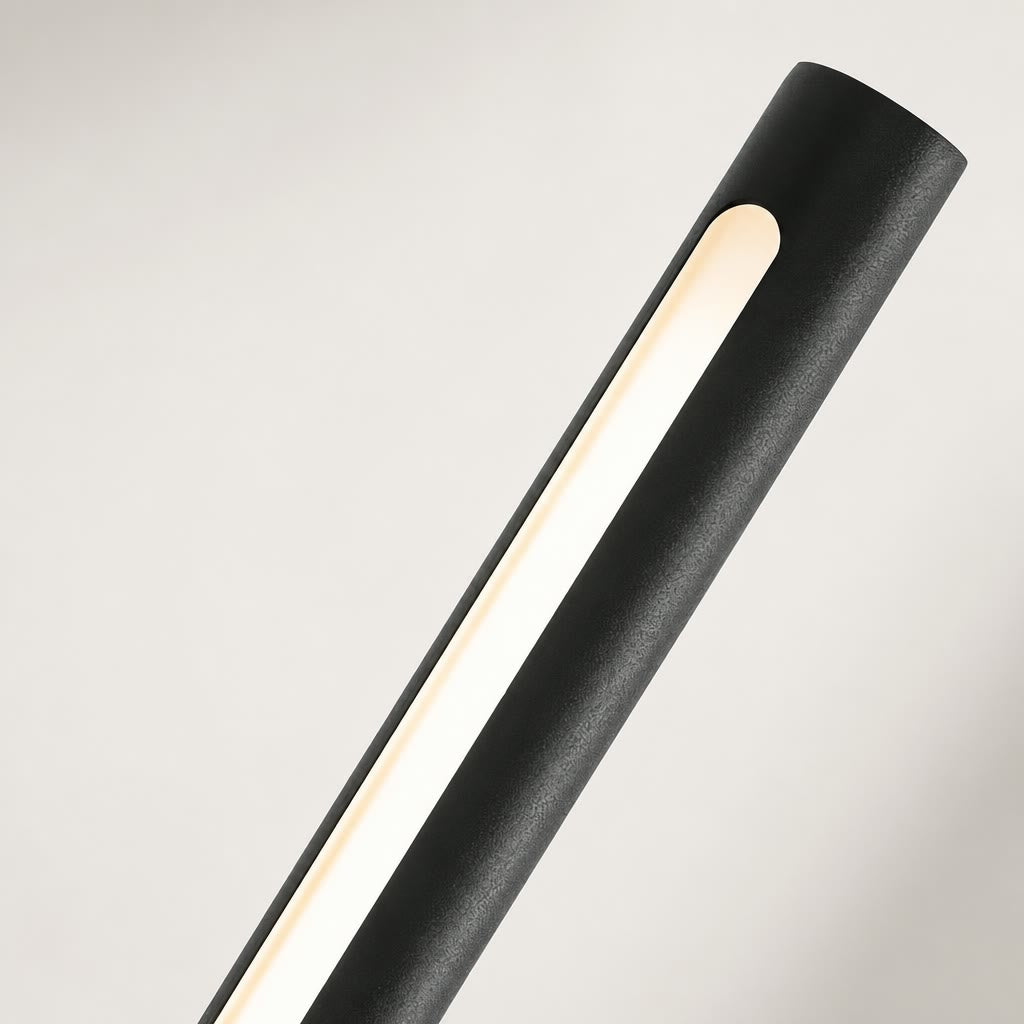 Black cylindrical light fixture with a warm vertical illuminated strip on a pale background.