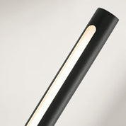 Black cylindrical light fixture with a warm vertical illuminated strip on a pale background.