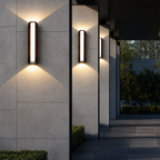 Three lit vertical wall sconces mounted on textured exterior columns.