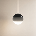 Glossy spherical pendant lamp with a black cord and shaded glass globe.