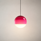 Pink and white spherical pendant lamp hanging from a thin cord.
