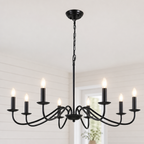 Black six-light candle chandelier with glowing bulbs hanging from a chain in a bright room.