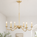Gold six-light chandelier with candle bulbs suspended from a chain in a bright modern room.