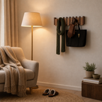 Wooden wall coat rack holding a scarf, gloves, tote bag, and key in a cozy entry nook.