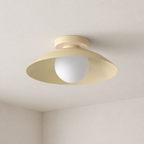 Cream flush-mount ceiling light with a wide saucer shade and frosted white globe.