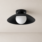 Black semi-flush ceiling light with a wide shade and white globe diffuser.