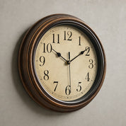Vintage round wall clock with a brown wooden frame and cream numbered face.