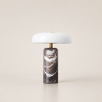 White dome table lamp with brass stem and dark brown marble cylindrical base.