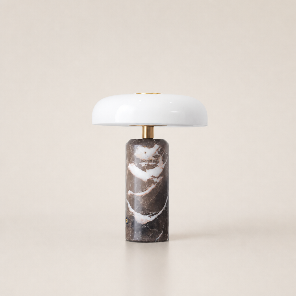 White dome table lamp with brass stem and dark brown marble cylindrical base.