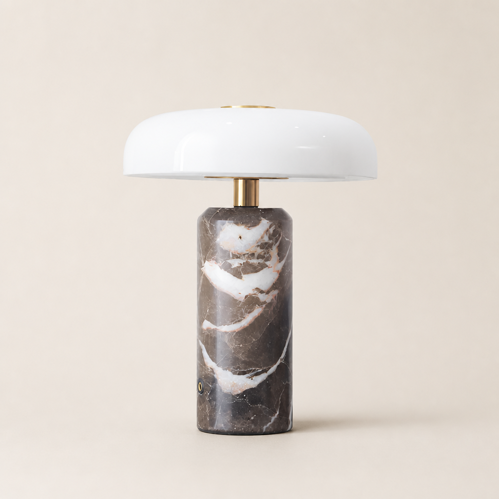 White dome table lamp with brass stem and dark marble cylindrical base.