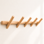 Light wood wall rack with five angled round pegs on a clean white background.