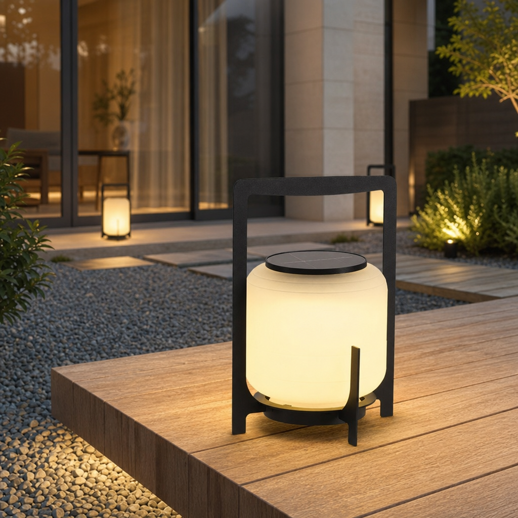 Glowing black handled solar lantern on a wooden patio in a modern garden setting.